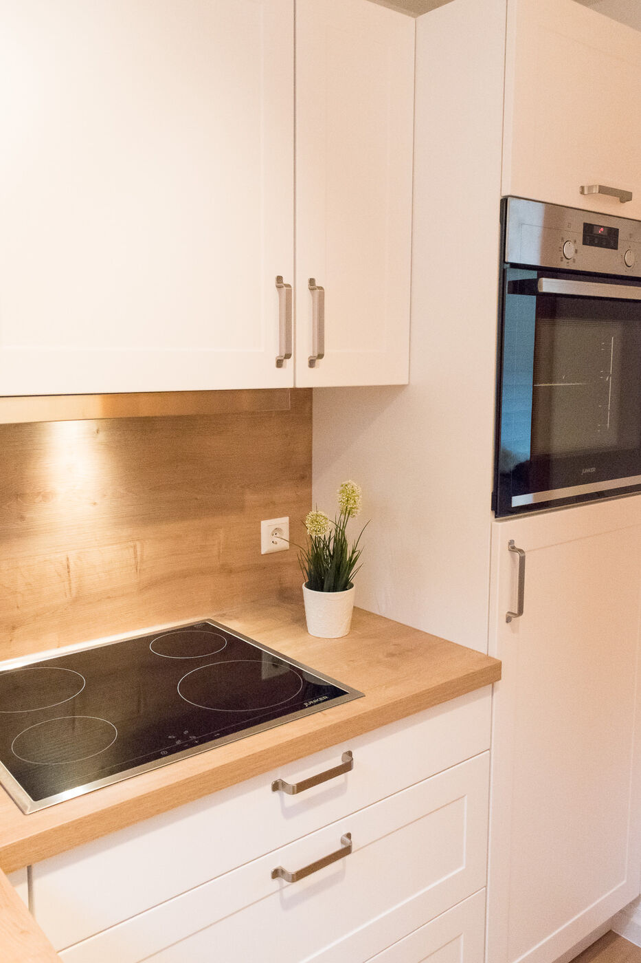 Moderne helle Küche mit Holzarbeitsplatte